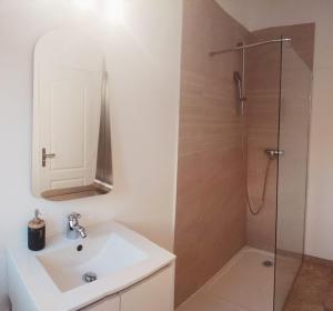 a bathroom with a sink and a shower at Résidence P&C Fragrance Studio in Neuilly-sur-Marne