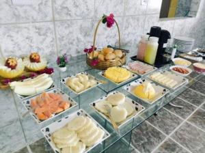 a buffet of food on top of a table at Pousada Sinai in Viçosa +4 photos