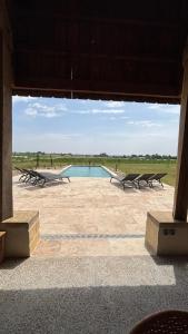 a view of a pool with benches around it at Cottage RG in Lamothe-Landerron