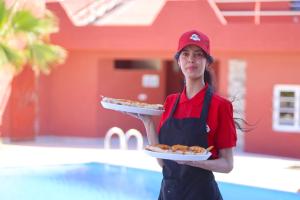 a woman is holding a plate of food at Palais D'orient  +39 photos