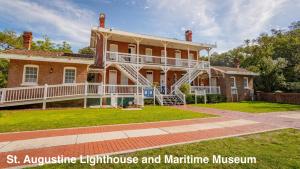 a large brick house with a large porch at Anastasia Island Treehouse in St. Augustine