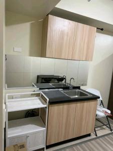 a kitchen with a sink and a counter top at AVIDA 1 2BR cloverleaf in Manila