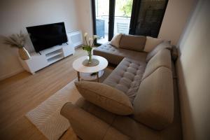 a living room with a couch and a tv at Apartman Superior Centar in Trebinje