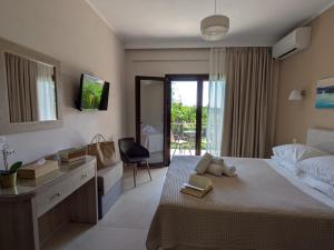 a bedroom with a bed with a desk and a chair at Casa Marina in Syvota
