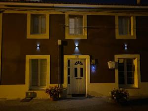 een huis met een witte deur 's nachts bij Casa Navia in Villanueva de Arosa