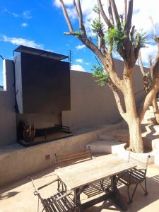 a wooden table and chairs next to a tree at Luxury Villa in Windhoek with Private Pool in Khomas Region