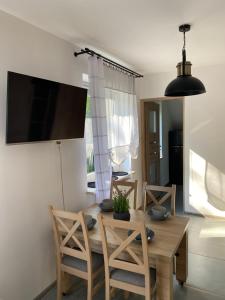 a dining room with a wooden table and chairs at Sielska Dolina in Jerzmanowice