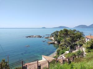 a view of a body of water with a fence at La Casa nel Carobio in Ameglia