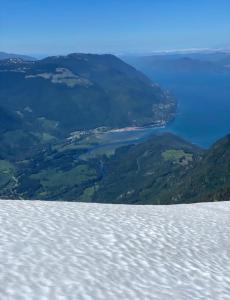 a view of a lake from the top of a mountain at Rustic Guesthouse in Sayward +8 photos