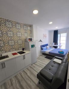a living room with a couch and a bed at Apartamentos Lindux Airport in Manises