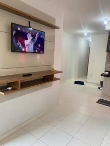 a living room with a flat screen tv on a wall at Apartment - Pedro Leopoldo in Pedro Leopoldo