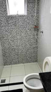 a bathroom with a shower with a toilet and a window at Apartment - Pedro Leopoldo in Pedro Leopoldo +7 photos