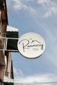 a sign for the romanery irish restaurant at The Roamery Hostel in Bangkok