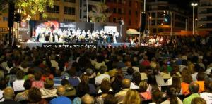 a large crowd of people watching a concert on a stage at AleAnto Playa in El Médano