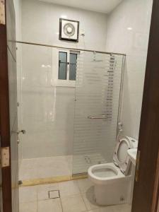 a bathroom with a toilet and a window and a camera at Luxury apartment, 3 bedrooms, living room, kitchen in Jeddah