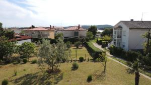 a view of a yard with houses and trees at Kosovic Family House in Medulin