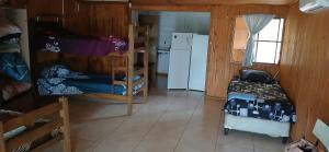 a room with a bunk bed and a refrigerator at Hostal DOÑA EMMA in Florida