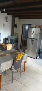 a kitchen with a refrigerator and a table and chairs at Hostal DOÑA EMMA in Florida