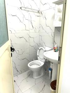a bathroom with a toilet and a sink at Aiden's House 2 in Vlorë