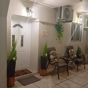 a living room with plants and a white door at Spiros dream house in Mesongi