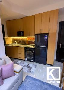 a kitchen with a washer and dryer in a room at Luxurious Family Chalet - Sia Lagoon, Porto Golf Marina, El Alamien - Lagoon View in El Alamein