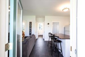 a living room and kitchen with a couch and a table at The Milkweed - 18 Meadow View in Cherry Valley