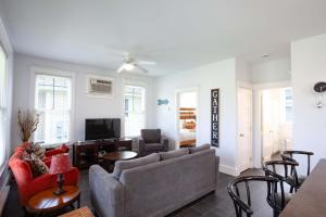 a living room with a couch and a tv at The Milkweed - 18 Meadow View in Cherry Valley +64 photos
