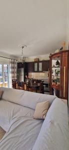 a large white bed in a room with a kitchen at Villa Violeta in Ksamil
