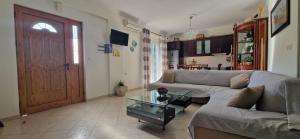 a living room with a couch and a table at Villa Violeta in Ksamil