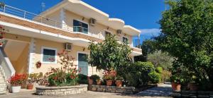 a house with potted plants in front of it at Villa Violeta in Ksamil