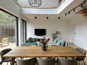 a living room with a table and a couch at Willa Horyzont Borsk in Borsk