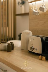 a toaster sitting on top of a wooden counter at Nemausa Luxury Living in Kallithea Halkidikis