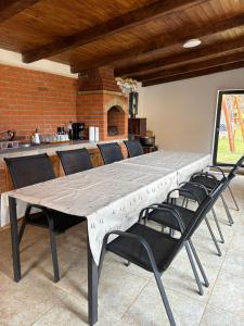 a large dining table with chairs around it at Tiny Teo Sătic in Satic