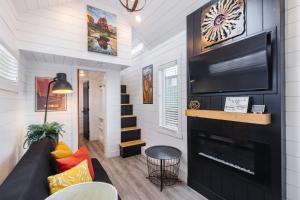 a living room with a tv and a fireplace at Hot Tub & BBQ Deck, Tiny Home Near Zion National Park in Apple Valley