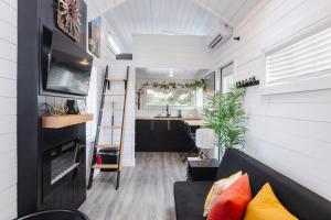 a tiny house with a kitchen and a living room at Hot Tub & BBQ Deck, Tiny Home Near Zion National Park in Apple Valley