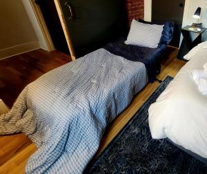 a bedroom with two beds and a blanket on the floor at Easy Access I TQL Stadium I Free Parking in Cincinnati