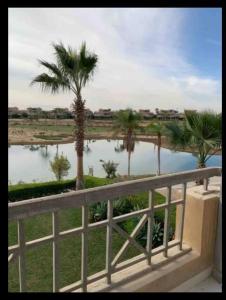 a view of a body of water with palm trees at Modern 4BDR duplex Lagoon View in Einbay in Ain Sokhna