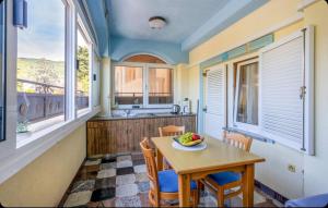a kitchen with a table with a bowl of fruit on it at Villa Ana Selce in Selce +13 photos