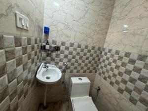 a bathroom with a toilet and a sink at Landour Apartment Beauty and Charm in Mussoorie