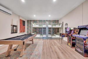 a room with a pool table and arcade games at 5Br Sleeps 16 Private Pool-Dog Friendly-Fire Pit in Lake Placid