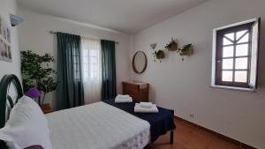 a bedroom with a bed and a window at Burgau Ocean View Apartment in Burgau