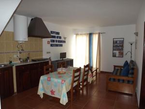 a kitchen and dining room with a table and chairs at Burgau Ocean View Apartment in Burgau