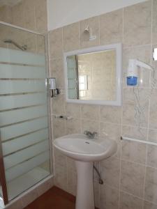 a bathroom with a sink and a shower with a mirror at Burgau Ocean View Apartment in Burgau +22 photos
