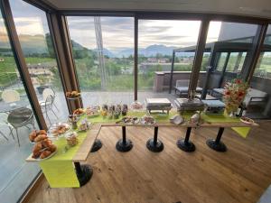 a table with food on it in a room with windows at Bihotel in Maiano
