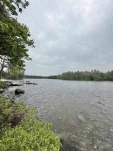 a large body of water with trees in the background at PARADISE POINT LIMIT 10 cottage in Casco