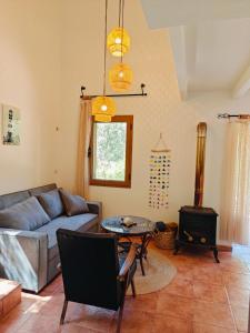 a living room with a couch and a wood stove at Kalives pearl suite in Kalyves