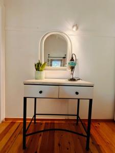 a white dresser with a mirror on top of it at Kalives pearl suite in Kalyves
