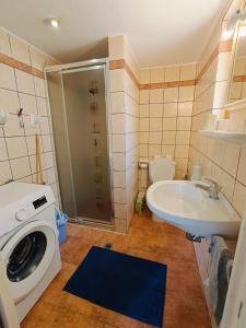 a bathroom with a washing machine and a sink at Kalives pearl suite in Kalyves +16 photos