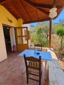 a table and chairs on a patio with a view at Kalives pearl suite in Kalyves