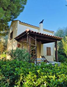 a house under construction in the middle of bushes at Kalives pearl suite in Kalyves